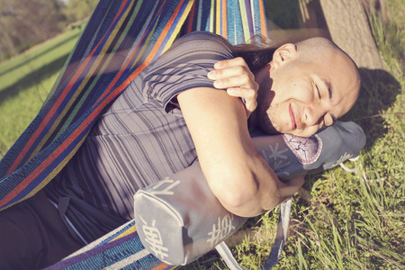Young man in nature posing with yoga mat bagの写真素材