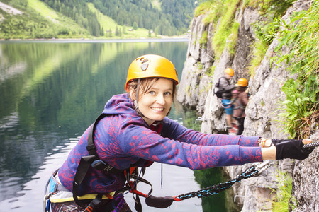 Woman climbing via ferrata, Gosausee, Austriaの写真素材