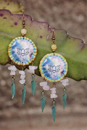 Romantic female earrings on natural backgroundの写真素材