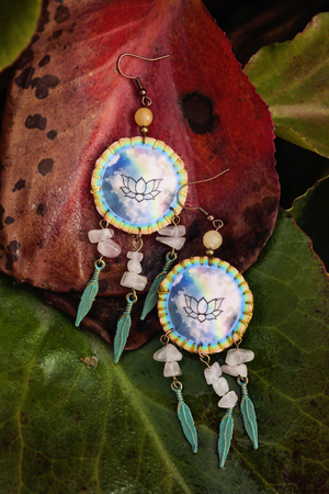 Romantic female earrings on natural backgroundの写真素材