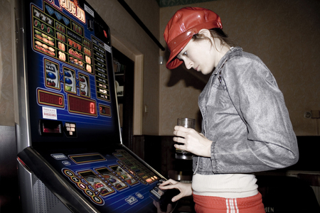 Young girl playing slot-machine, July 2009, Illustrative Editorial