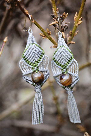 Romantic earrings hanging on natural backgroundの写真素材