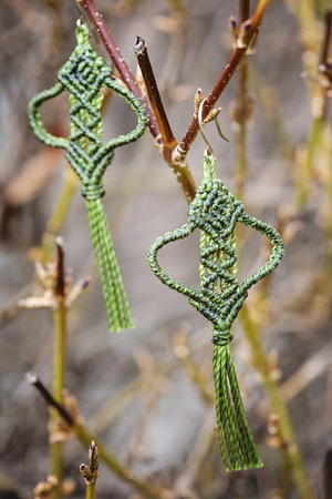 Romantic earrings hanging on natural background