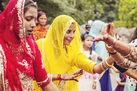 Udaipur, Rajasthan, India, February 6, 2018: Young Indian girls in traditional sari, dancing at wedding crowd on the streetのeditorial素材