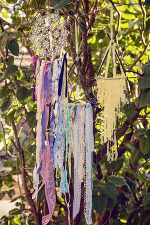 Dream catchers hanging on tree bushの写真素材