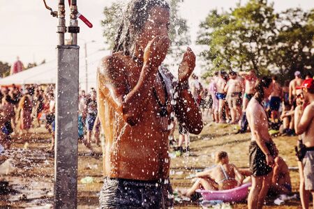 KostrzynÂ nad Odra, Poland, August 4, 2018, Woodstock Poland Rock festival visitor taking showerのeditorial素材