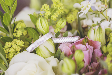 White gold wedding rings on wedding flowerの写真素材