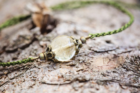 Tiny fashionable female bracelet on wooden backgroundの写真素材