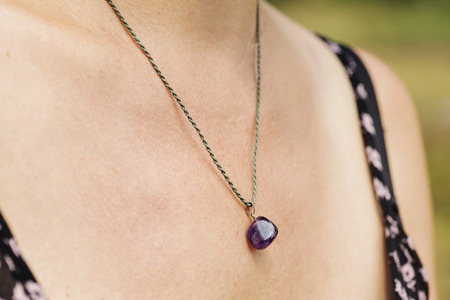 Woman wearing a Amethyst pendant necklaceの写真素材