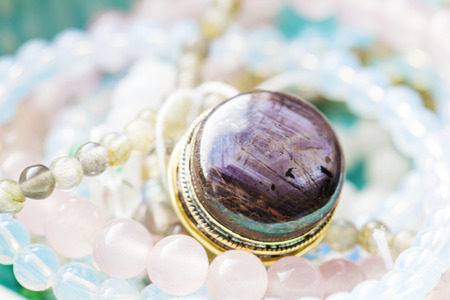 Natural mineral stone beads in decorative bowlの写真素材