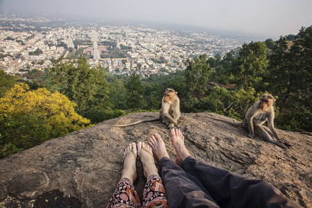 Couple legs sitting at Arunachala mountain view, Tiruvannamalai, Tamil Nadu, Indiaの写真素材