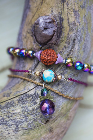 Three fashionable mineral stone beads bracelets on wooden background