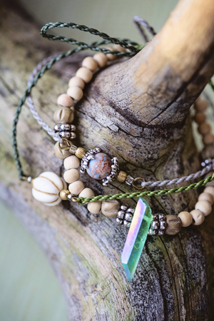 Natural stone beads macrame bracelets on wooden backgroundの写真素材