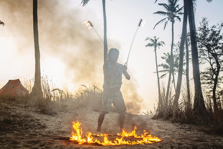Man doing fire show at Arambol beach in Indiaの写真素材