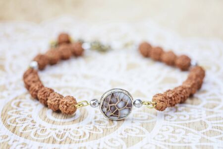 Mother pearl natural bead rudraksha seed bracelet on decorative backgroundの写真素材