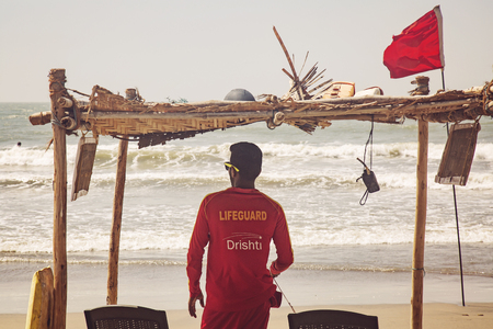 Arambol, Goa in India, February 9, 2019: Lifeguard watching the sea at Arambol beachのeditorial素材