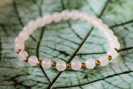 Mineral stone jade mineral beads fashionable bracelet on green backgroundの写真素材