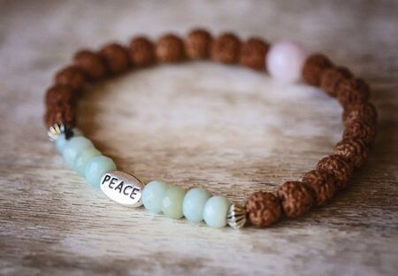 natural mineral stone beads yoga bracelet on natural wooden backgroundの写真素材
