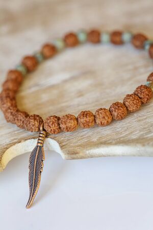 natural mineral stone beads yoga bracelet on natural wooden backgroundの写真素材