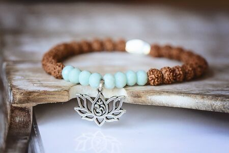 natural mineral stone beads yoga bracelet on natural wooden backgroundの写真素材