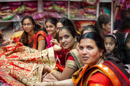 Udaipur city in India, February 8, 2018: Women shopping sari in Udaipur center textile storeのeditorial素材