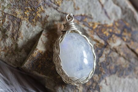 Beautiful moon stone pendant on rocky backgroundの写真素材