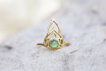 Golden metal silver ornamental ring with red jade mineral stoneの写真素材