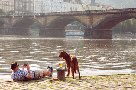 Prague, Czech republic, June 13, 2020: Prague Vltava waterfront, people enjoying sunset time at the quayのeditorial素材