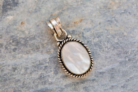 Natural gemstone pendant in silver metal decorative oval on natural backhroundの写真素材