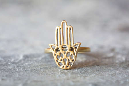 Elegant silver ring with citrine gemstone on rocky background