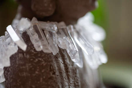 Close up detail still life of Buddha statue with crystal quartz necklaceの写真素材