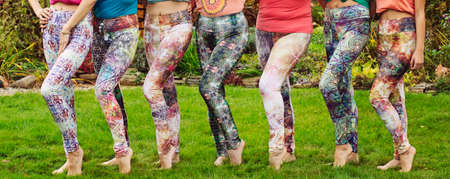 Female legs wearing colorful leggins outdoor barefoot
