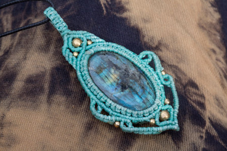 Lapis lazuli gemstone macrame pendant on natural background