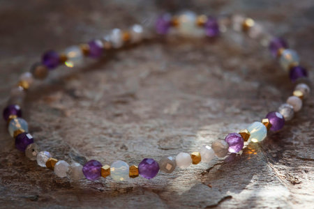 Mineral gemstone bracelet placed on natural grey backgroundの写真素材