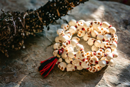 White stone skull beads necklace mala on rocky backgroundの写真素材