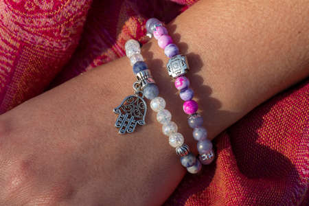 Female hand wearing mineral stone beads braceletsの写真素材