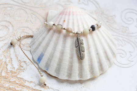 Beautiful mineral stone and metal components necklace on white shellの写真素材