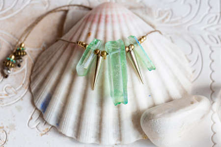 Beautiful mineral stone and metal components necklace on white shellの写真素材