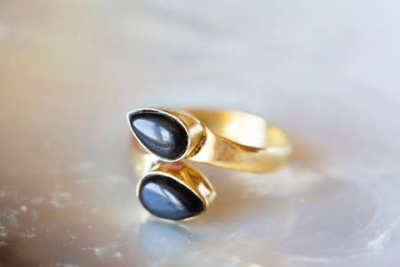 mineral stone brass ring on natural backgroundの写真素材