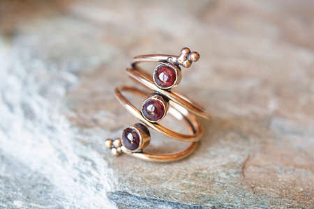 mineral stone brass ring on natural backgroundの写真素材