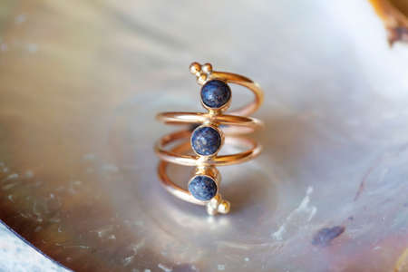mineral stone brass ring on natural backgroundの写真素材
