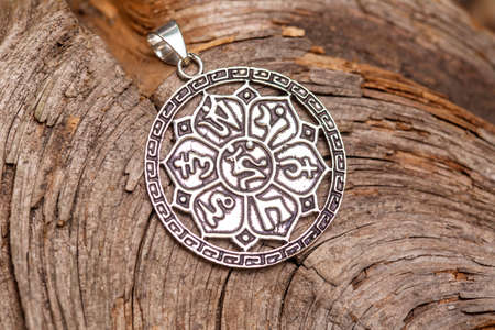 Brass metal pendant on natural background in the shape of dragonの写真素材