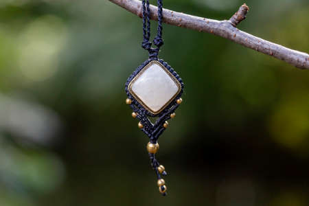 Boho necklace on natural background with white moonstone
