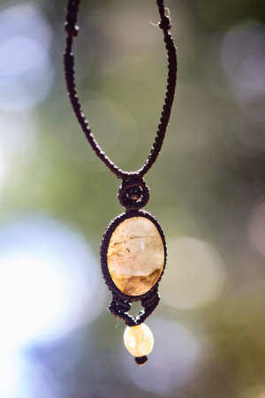 Boho necklace on natural background with white moonstoneの写真素材
