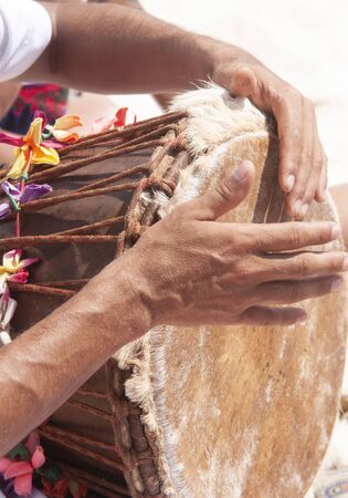 Musician playing drums at ceremony on the beach, Mexicoの写真素材