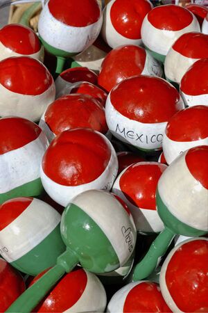 Handmade Mexican maracas in local market. Maracas for sale. Close-up of colorful handmade wooden toys, top down view.の写真素材