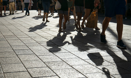 Urban shadows of people walking on a sunny street in Playa del Carmen, Mexicoの写真素材