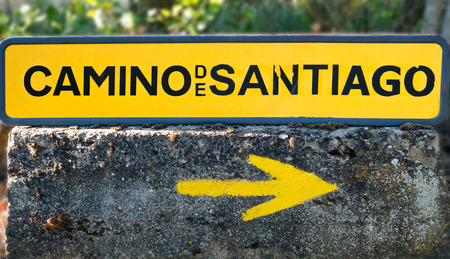Traditional yellow arrow painted on the way. Direction sign for pilgrims in Saint James way, Camino de Santiago de Compostela, Spainの写真素材