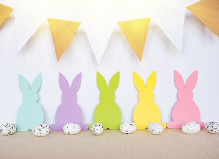 Easter background with eggs, rabbits and garland flagsの写真素材