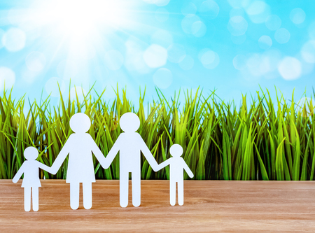 Paper cut of family with green grass backgroundの写真素材